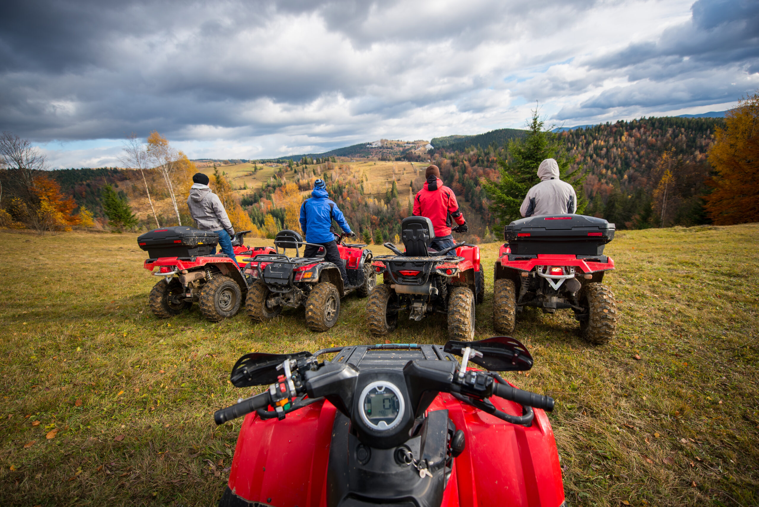 View from quad bike. Four men at ATV enjoying beautiful landscape