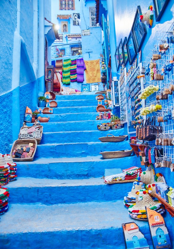 Many different Souvenirs and gifts in the streets of Chefchaouen. Paintings, carpets, clothing and handmade products on the streets of Morocco. Morocco, Chefchaouen 13 Dec 2017